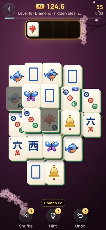 Tray mode: a diamond of big ivory tiles, two frozen in ice, with a maple leaf waiting in the four-slot tray.